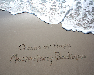 Oceans of Hope written on sand with water